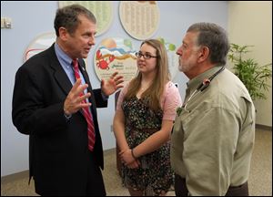 U.S. Sen. Sherrod Brown talks with Rachel Burns, a 15-year-old Springfield High School student and cystic fibrosis patient, and Dr. Pierre Vauthy, Director of Pedicatric Pulmonary Medicine at Toledo Children's Hospital, following a news conference at Toledo Children's Hospital.