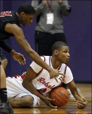 Bowsher's Aundre Kizer goes to the floor against Scott's Jermul Richardson. Kizer led the Rebels with 24 points.