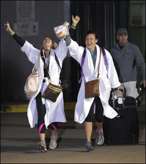 Kendall Jenkins, left, of Houston, celebrates with a friend after getting off the Carnival Triumph on Thursday night in Mobile, Ala.