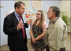 U.S. Sen. Sherrod Brown (D., Ohio) speaks with Rachel Burns, 15,  a cystic fibrosis patient, and Dr. Pierre Vauthy, director of pedicatric pulmonary medicine, at Toledo Children’s Hospital.