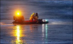 A rescue crew takes a hovercraft into icy water to rescue two dogs who were stranded on an ice floe on the Maumee Bay for almost 10 hours.