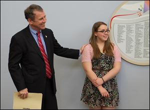 U.S. Sen. Sherrod Brown stands with Rachel Burns, a 15-year-old Springfield High School student and cystic fibrosis patient, during a news conference today at Toledo Children's Hospital.