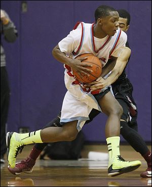 Bowsher's Dajuan King tries to get past Scott's Chris Harris in Friday night's City League semifinal at Waite’s fieldhouse.