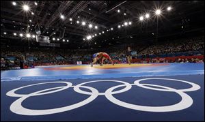 Sayed Abdelmonem Hamed of Egypt competing against Zaur Kuramagomedov of Russia (in blue) during the 60-kg Greco-Roman wrestling competition at the 2012 Summer Olympics in London.