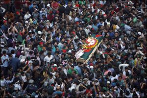 Bangladeshi mourners carry the coffin containing the body of blogger Rajib Haider, 30, for funeral services today in Dhaka, Bangladesh.