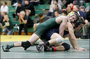 Clay junior Jared Davis, left, attempts to spin Anthony Wayne junior Vince Schneider at 113 pounds. 