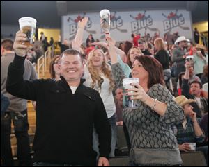 Duane and Katrina Parsell of Findlay raise their glasses prior the Luke Bryan concert Friday at the Huntington Center in Toledo.