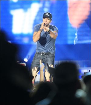 Singer Luke Bryan entertains the crowd, which was on its feet, in Toledo.