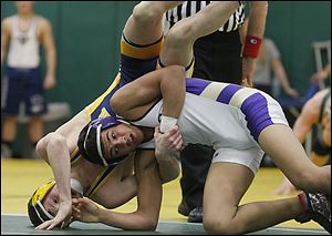 Maumee's Anthony Arroyo, right, topped Whitmer's Logan Cluckey in the 138 final with a 12-10 victory.