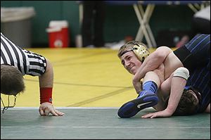 Perrysburg’s Ryan Roth struggles to finish a pin over Anthony Wayne’s Collin Keil during the 145 final.