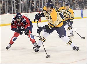 Toledo's Wes O'Neill attacks the goal while defended by Kalamazoo's Elgin Reid.