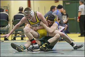 Whitmer junior James Wingate, left, is taken down by Clay senior Brian Hennemen during Division I Sectional 126-pound championship match Hennemen won, 11-2.