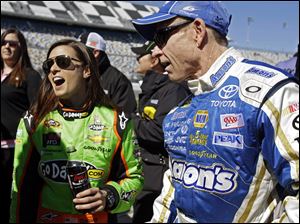 Mark Martin, right, and Danica Patrick laugh on pit road after their qualifying runs for the NASCAR Daytona 500 Sprint Cup Series auto race at Daytona International Speedway, in Daytona Beach, Fla. Patrick won the pole, becoming the first woman to secure the top spot for any Sprint Cup race. 