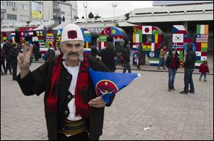 A Kosovo Albanian man gives a victory salute as he walks past the 