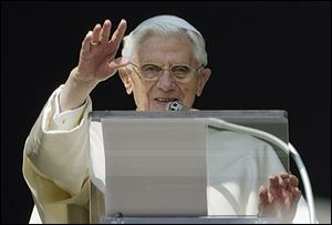 Pope Benedict acknowledges the cheering crowd Sunday during his next-to-last Angelus prayer from the window of his apartment at the Vatican.