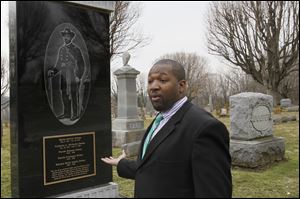 Roderick Blount stops by the tombstone of Martin Delany, who rests at the center of the cemetery outside Wilberforce, Ohio. Former Toledo Mayor Jack Ford was among those who helped  raise money for the marker.