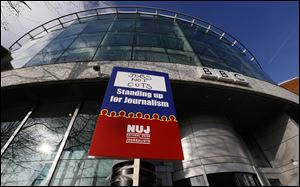 A National Union of Journalists, NUJ, placard is seen taped to a post outside the BBC Television Centre in White City, London. BBC journalists have gone on strike for 24 hours after the NUJ failed to reach an agreement with management in a disagreement over redundancies.