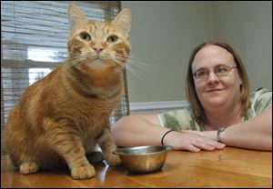 Toledoan Crystal Lawson feeds her cat Joey prescription food. Joey is recovering from urinary tract issues, which are the ‘number-one problems cats have,’ Dr. Gary Thompson says.