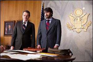 This film image released by Warner Bros. Pictures shows Bryan Cranston, left, as Jack ODonnell and Ben Affleck as Tony Mendez in 