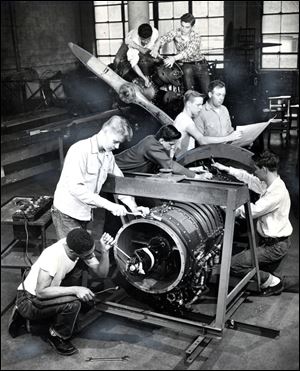 Students and their instructor work on a Westinghouse J-34 Turbo Jet engine at Macomber.  During World War II, Macomber focused on defense and operated around the clock, according to a Blade article.