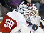  The Red Wings’ Jonas Gustavsson blocks a shot in the second period. He had to replace starter Jimmy Howard, who left in the first with an upper-body injury.