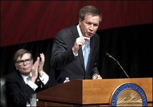 Gov. John Kasich says he will continue resisting calls to spend the surplus Ohio has built up. He wants to cut taxes for individuals and businesses by a total $1.4 billion.