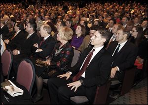 State Treasurer Josh Mandel, center, who lost his election bid to the U.S. Senate in November, listens to Gov. John Kasich's State of the State address at the Veteran's Memorial Civic & Convention Center in Lima.