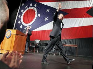 Gov. John Kasich waves after giving his State of the State address in Lima in February. His proposed budget before the General Assembly includes progressive proposals as well as negative ones. 