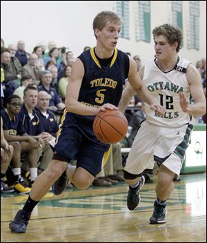 Toledo Christian's Eric Cellier drives against Ottawa Hills' Judah Wollenburg. Cellier leads the Toledo Area Athletic Conference with a 21.7 scoring average.
