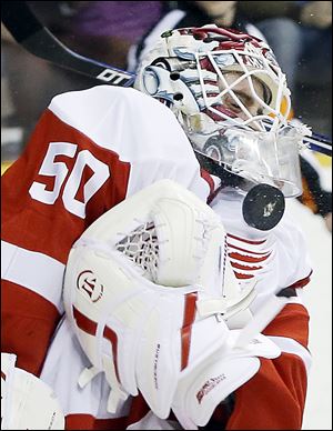 The Red Wings’ Jonas Gustavsson blocks a shot in the second period. He had to replace starter Jimmy Howard, who left in the first with an upper-body injury.