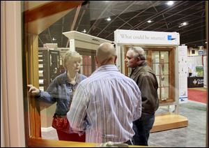 Cindy Miller, left, and husband Mike Miller, right, of Belvedere, Ohio, ask Todd Gruppi questions during the 2012 House & Home Show. HBA’s Bill Brennan says the show has virtually sold out of exhibit space for this year’s edition.