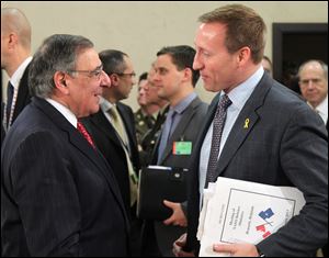 Canada's national defense minister Peter Gordon MacKay, right, talks with U.S. Secretary of Defense Leon Panetta, at the start of a two-day NATO defense ministers meeting to discuss Syria and Afghanistan, at NATO headquarters in Brussels, today.