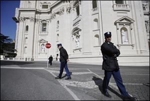 Vatican Police guards patrol in front of the St. Peter's Basilica, at the Vatican.
