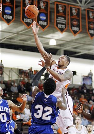 Bowling Green's A'uston Calhoun shoots over New Orleans' Lovell Cook during the first half. Calhoun led BG with 16 points as the Falcons earned the nonconference win to improve to 11-15.