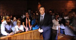 Olympic athlete, Oscar Pistorius , in court in Pretoria, South Africa, for his bail hearing charged with the shooting death of his girlfriend, Reeva Steenkamp.