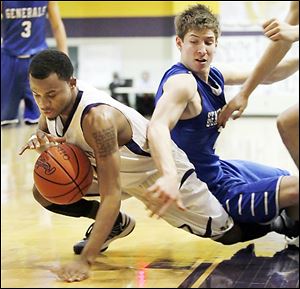 Maumee's Dominique King, left, who led the Panthers with 16 points, battles Anthony Wayne's Jake Reid.