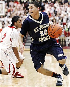 St. John's player Tyler Thompson drives past Central Catholic's D.J. Moody during their game Friday night.