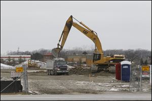 Land is cleared as work in underway to build a Kroger at the former site of an Ed Schmidt auto dealership at the corner of Dussel and Conant in Maumee.