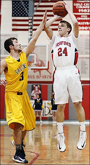 Bedford's Dylan Barr shoots against Saline's Reece Dils. Bedford improved to 15-3 on the season.