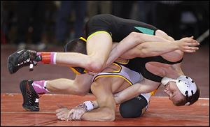 Delta's Kyle Keller, top, works to turn Archbold's Damian Short to his back en route to his win during their Division III 120 pound district final match at the Stroh Center on Saturday.