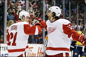 Detroit Red Wings center Tomas Tatar (21) is congratulated by right wing Patrick Eaves after scoring during the second period against the Predators.