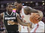  Ohio State's Deshaun Thomas, right, drives to the basket against Michigan State's Branden Dawson on Sunday in Columbus. Deshaun Thomas added 12 of his 14 points in the second half for the Buckeyes (20-7, 10-5 Big Ten), who stand fifth in the conference.