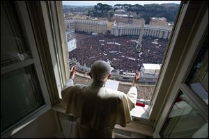 Pope Benedict XVI delivers his blessing during his last Angelus noon prayer, from the window of his studio overlooking St. Peter's Square, at the Vatican, today.