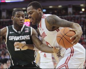 Ohio State's Deshaun Thomas, right, drives to the basket against Michigan State's Branden Dawson on Sunday in Columbus. Deshaun Thomas added 12 of his 14 points in the second half for the Buckeyes (20-7, 10-5 Big Ten), who stand fifth in the conference.