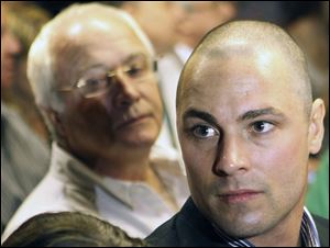 Carl Pistorius, right, the brother and father of Olympic athlete Oscar Pistorius, attend Oscar's bail hearing at the magistrate court in Pretoria, South Africa, last week.