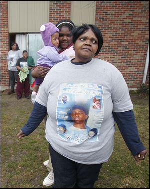 Gwendolyn Robinson, front,  dons a shirt memorializing her son. 