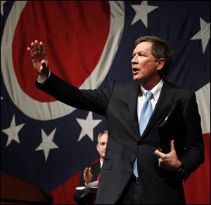 Gov. John Kasich waves after delivering his State of the State address at the Veterans Memorial Civic and Convention Center in Lima.