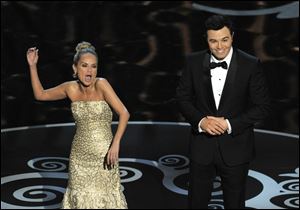 Host Seth MacFarlane, right, and actress Kristin Chenoweth perform a song dedicated to the 