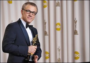 Actor Christoph Waltz poses with his award for best actor in a supporting role for 