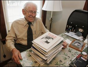 Ray Fahle of Bowling Green shows some of the books he has written, including his first, ‘My Life as a Barber.’ He turns 100 on March 6. A party is planned March 9 at First United Methodist Church. 